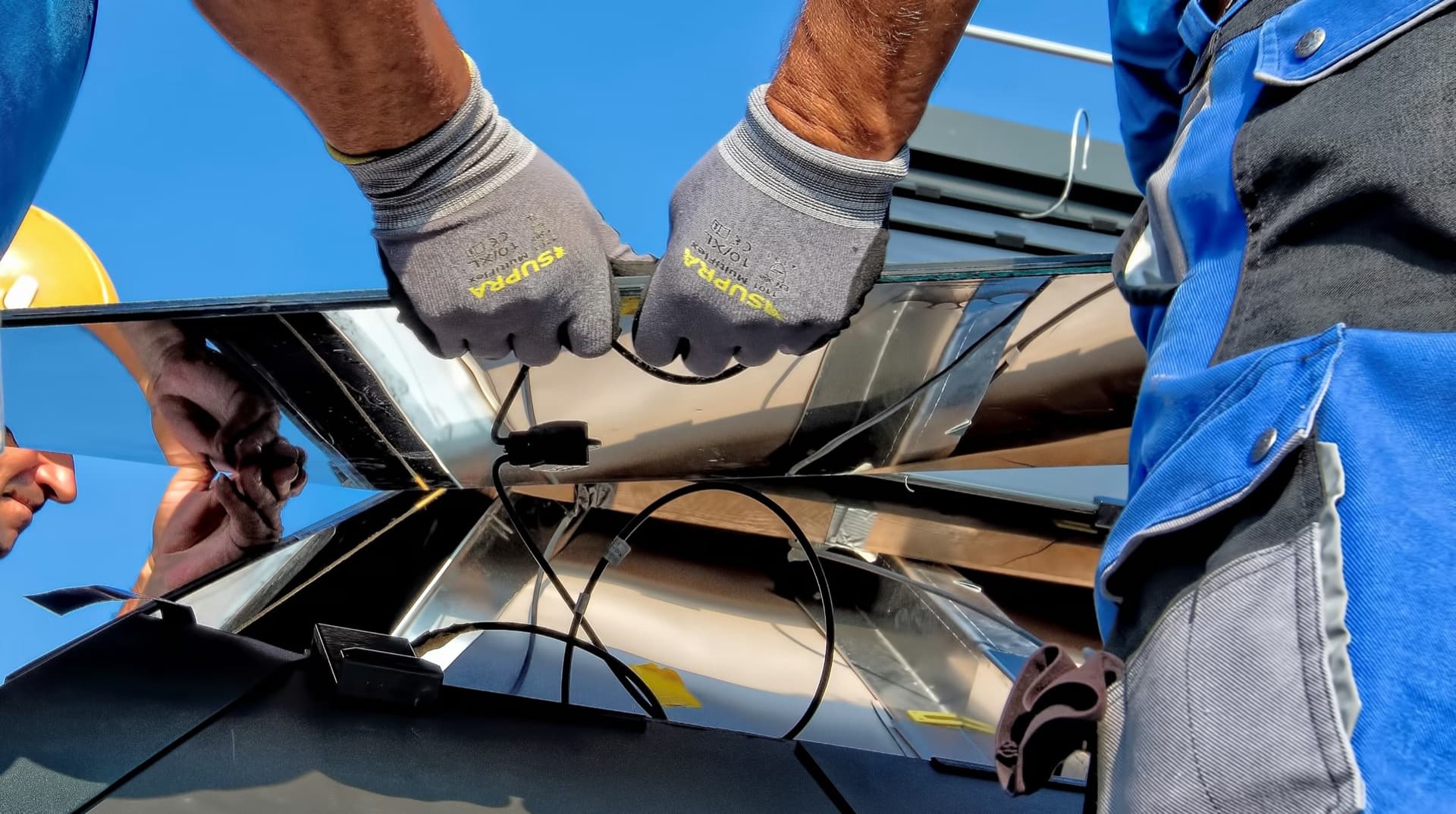 Solar panel installers working on a residential rooftop installation