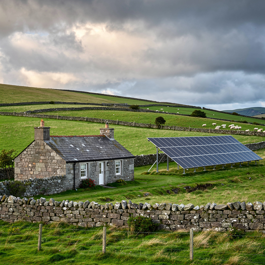 Irish stone cottage with ground-mounted solar array in the countryside