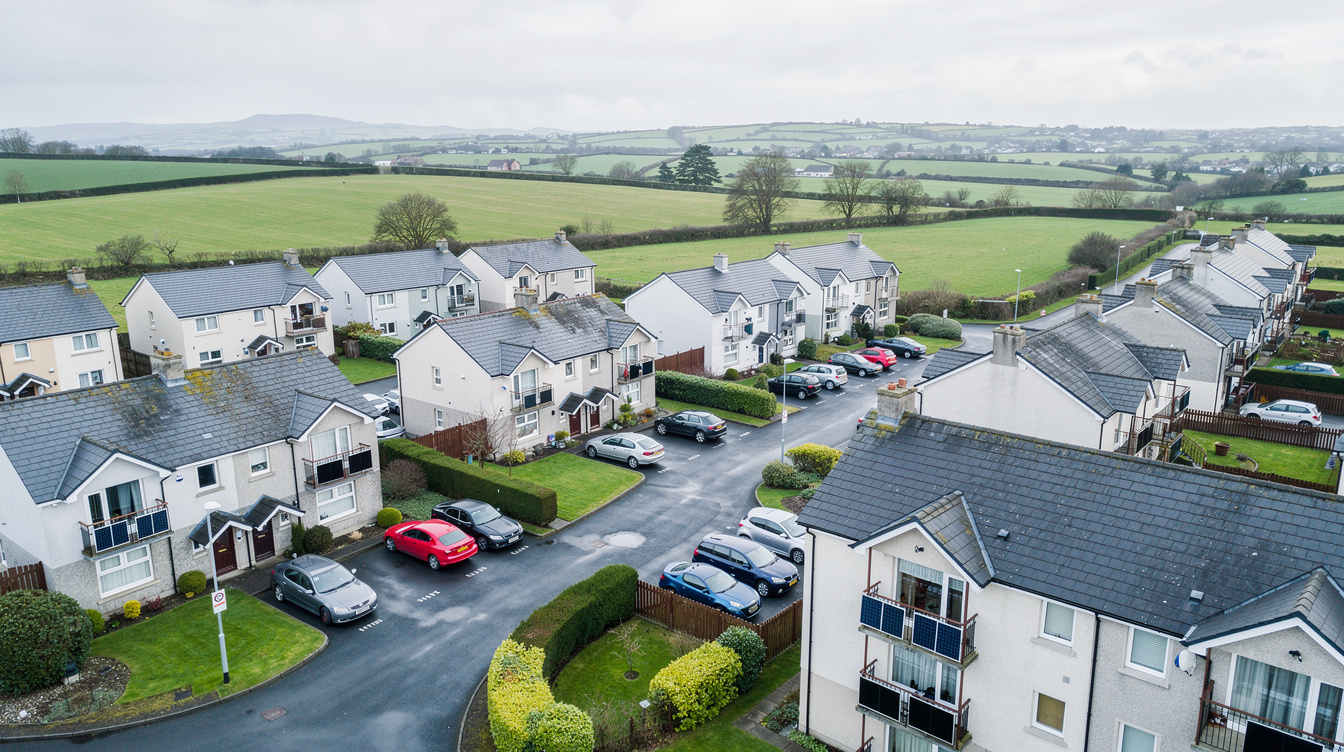 Aerial view of Irish housing estate with green fields in the distance