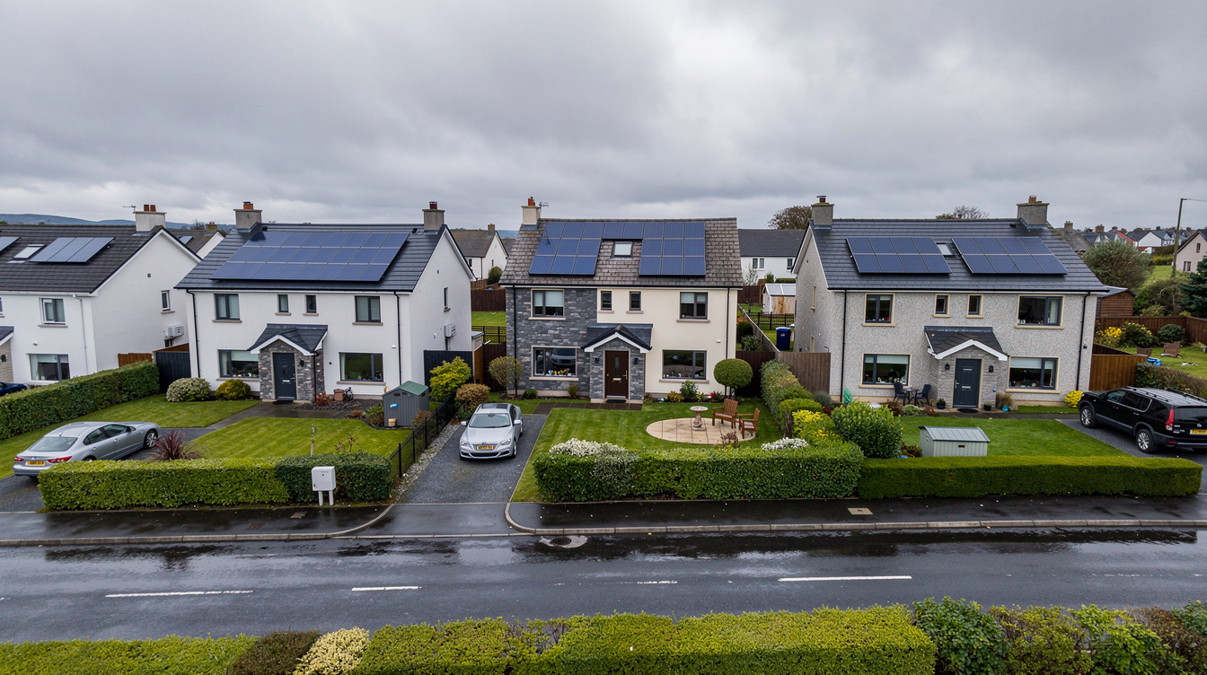 Row of Irish detached and semi-detached houses in a modern estate, some with solar panels on the roof